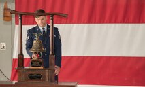 A firefighter rings a bell
