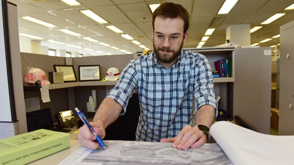 Civil Engineer Stephen Reed, U.S. Army Corps of Engineers Nashville District, reviews plans Sept. 23, 2024, for the Red River Harbor CAP 107 Project at Nashville District Headquarters in Nashville, Tennessee. Reed is the district’s employee of the month for June 2024. (USACE Photo by Lee Roberts)