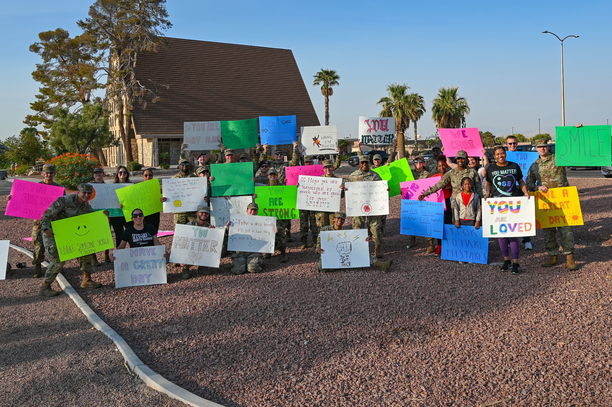Airmen pose for a group photo during a Suicide Prevention Awareness Month base wave-in