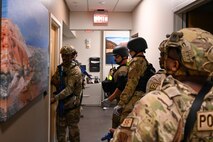 Airmen assigned to the 99th Security Forces Squadron clear a room during an exercise