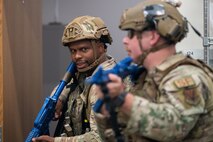 Security Forces Squadron specialist investigators, inspect a room during an exercise