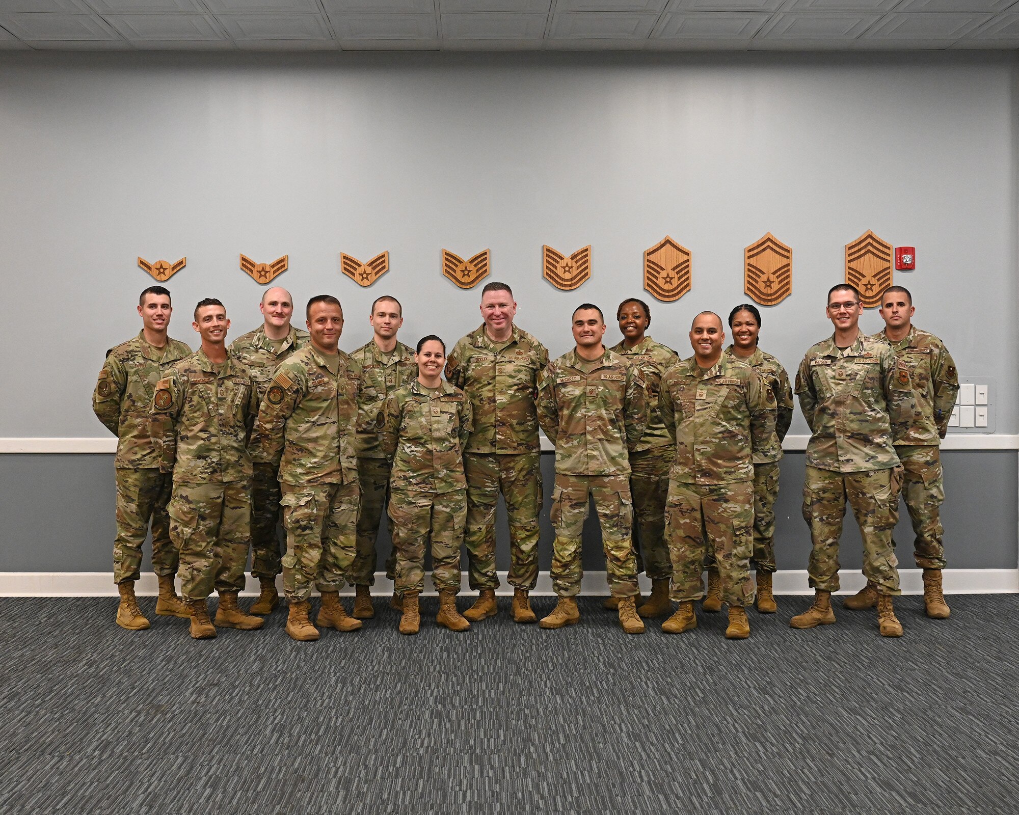 Chief Bickley poses with a group of Airmen.