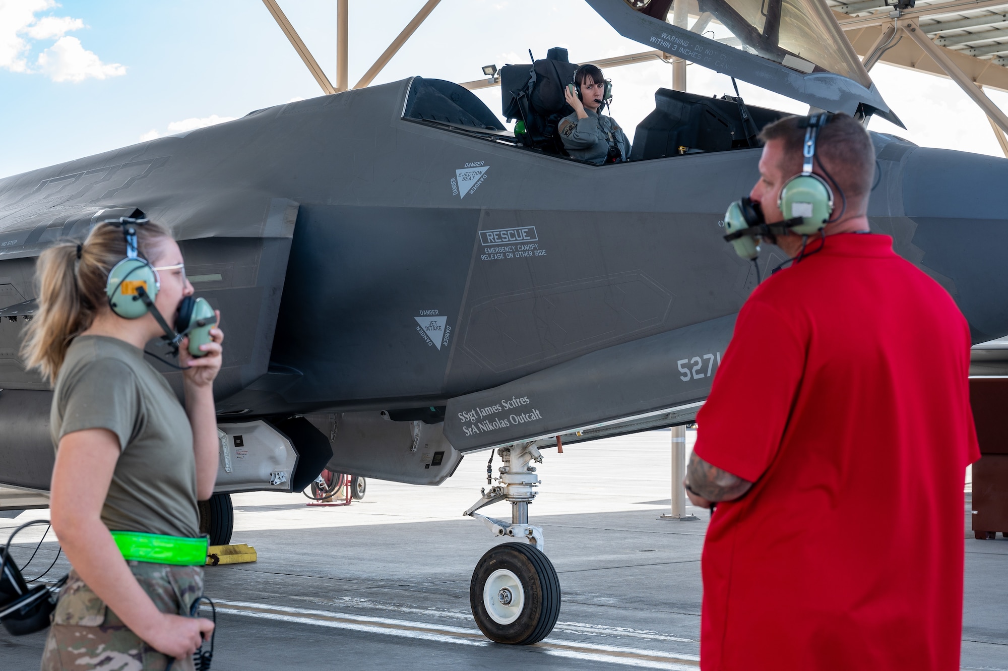 Three people conducting an F-35 engine run