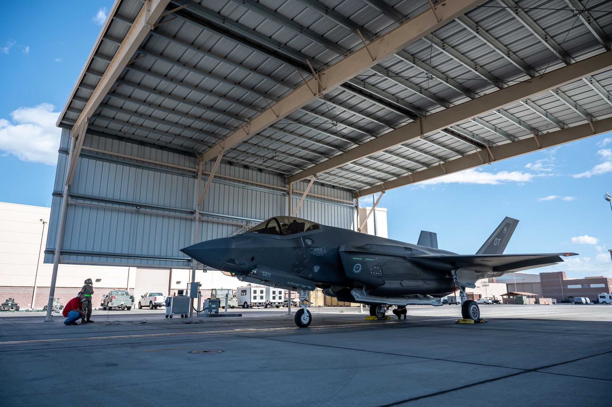 Three people conducting an F-35 engine run