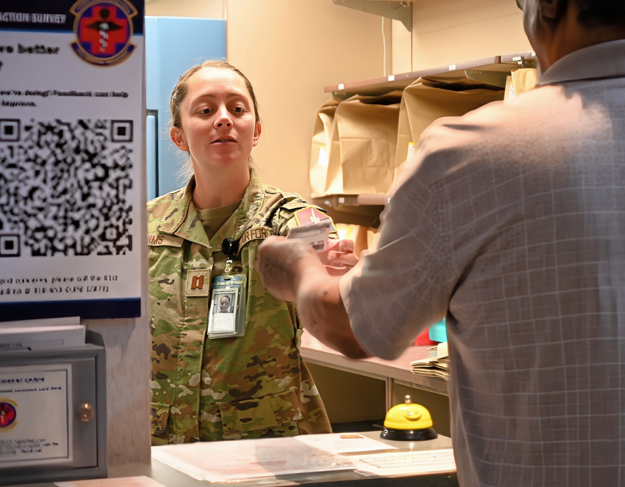 Pharmacy Element Chief Capt. Xrystina Nims, 61st Medical Squadron (MDS), Space Base Delta 3 at Los Angeles Air Force Base (LA AFB), receives a written prescription from a patient.