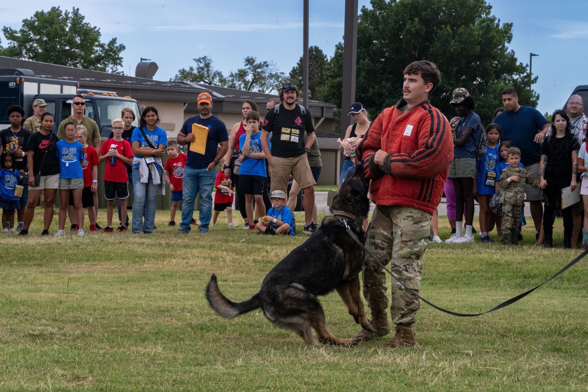 Team McConnell demonstrates the capabilities of Military Working Dogs for the annual Family Mobility Line Sept. 21, at McConnell Air Force Base, Kansas. The MWD demonstration was part of the event for service members’ families to experience and understand the deployment process. (U.S. Air Force photo by Airman 1st Class Paula Arce)