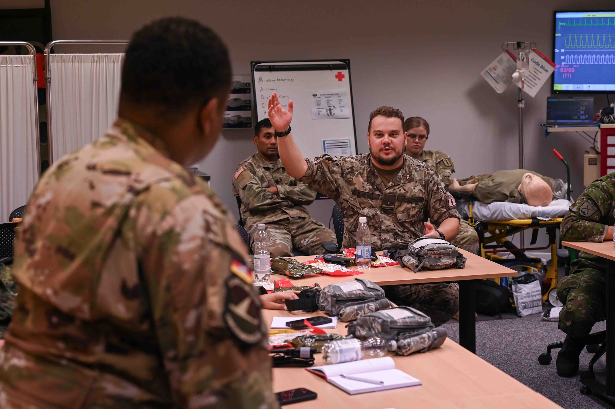 European Role 1 Development participants receive a debrief after a training session on Ramstein Air Base, Germany, Sept. 18, 2024. The training fostered the exchange of critical battlefield trauma skills and best practices with medics from Bulgaria, Bosnia and Herzegovina, Montenegro and Slovakia. (U.S. Air Force photo by Airman 1st Class Dylan Myers)