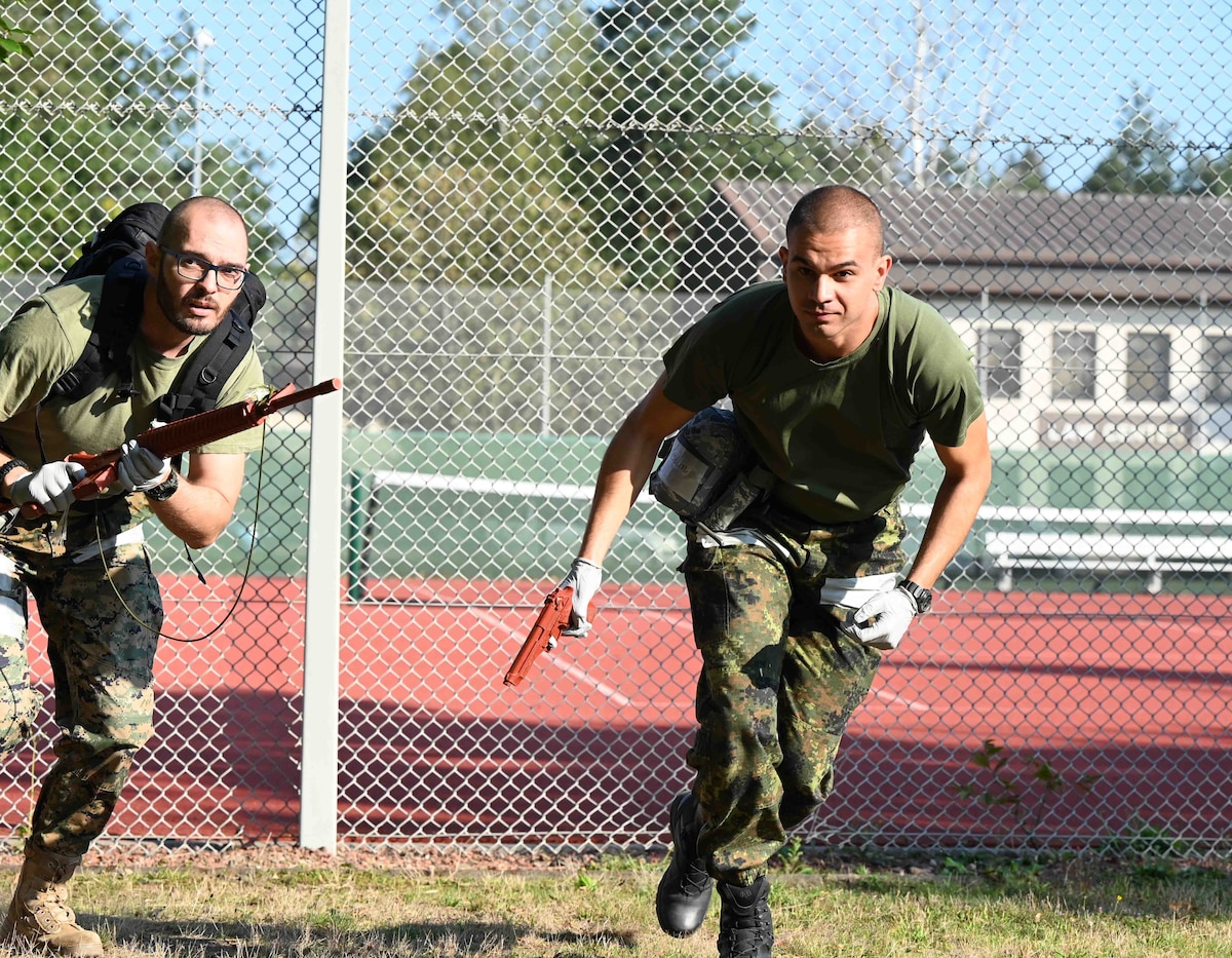 NATO and allied partners simulate clearing an area for medical evacuation at Ramstein Air Base, Germany, Sept. 19, 2024. The United States Air Forces in Europe - Air Forces Africa Office of the Command Surgeon hosted this engagement to ensure  unified medical preparedness and mission readiness across the European theater. (U.S. Air Force photo by Airman 1st Class Dylan Myers)