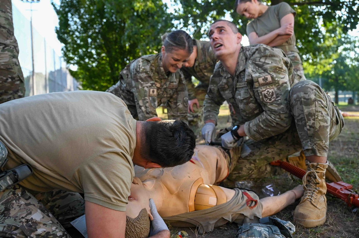Service members from Montenegro, Bosnia and Herzegovina provide simulated tactical combat casualty care at Ramstein Air Base, Germany, Sept. 19, 2024. High stress combined forces engagements like the European Role 1 Development week allow for improvisation and the strengthening of interoperability amongst allied countries. (U.S. Air Force photo by Airman 1st Class Dylan Myers)