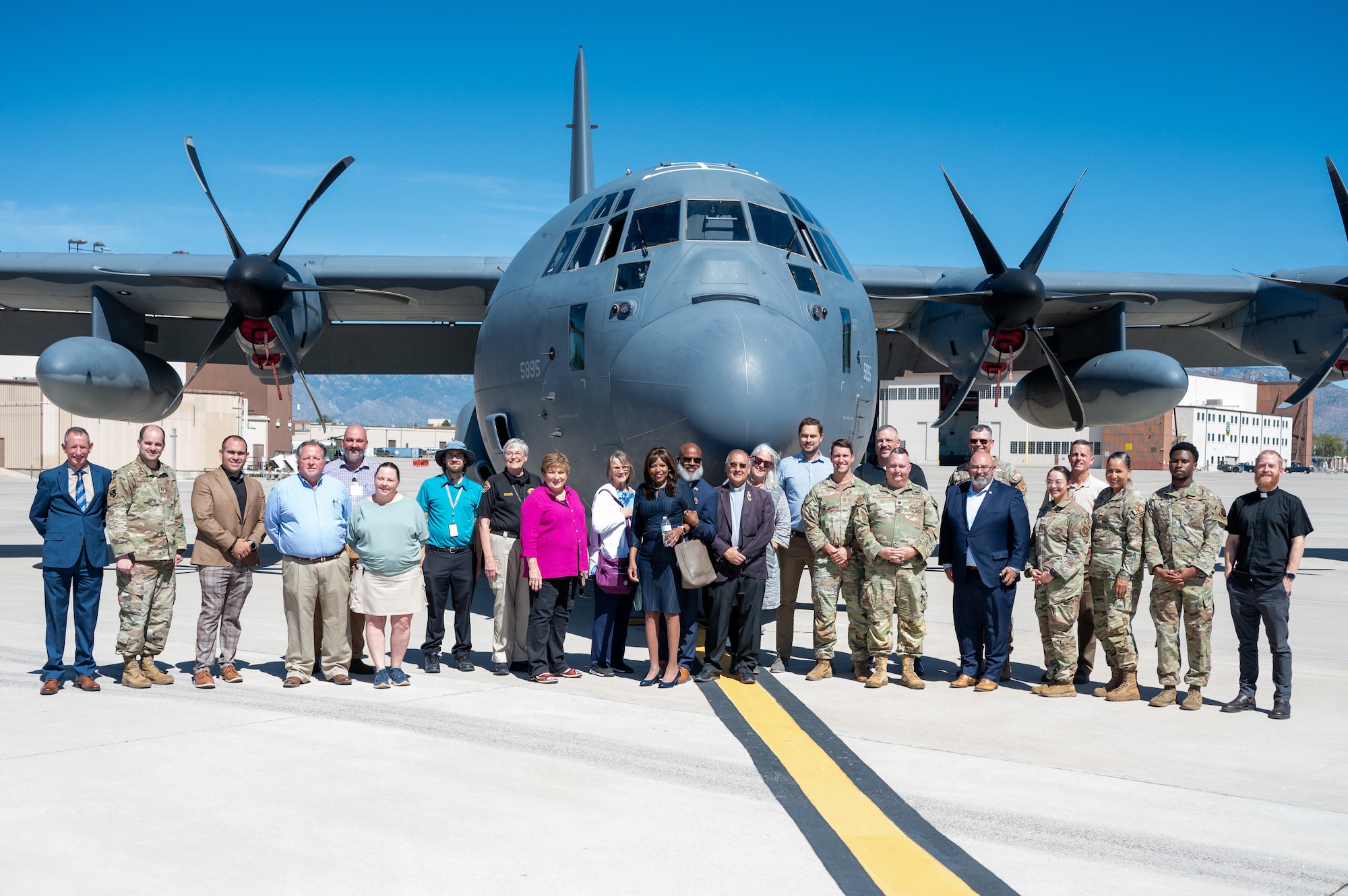 Public religious leaders pose in front of a MC-130J.