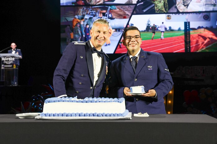 U.S. Air Force Col. Keagan McLeese, 9th Reconnaissance Wing commander, and Airman Kelvin Garcia, 48th Intelligence Support Squadron cyber operations technician, perform the cake cutting ceremony during the Beale Air Force Ball 2024 commemorating the 77th birthday of the U.S. Air Force at Wheatland, California, September 12, 2024