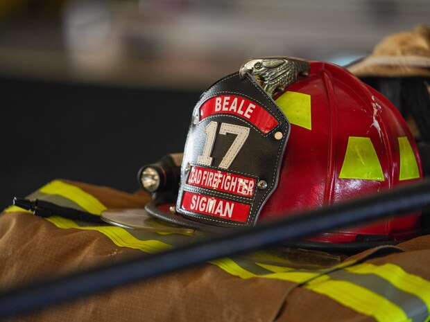 A firefighter helmet belonging to the 9th Civil Engineer Squadron is displayed on stage during a 9/11 remembrance ceremony at Beale Air Force Base, California, Sept. 11, 2024.