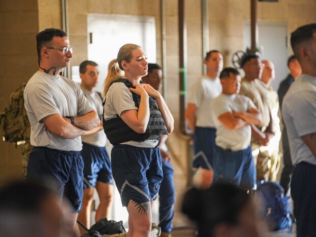 9th Reconnaissance Wing Airmen listen to remarks during a 9/11 Remembrance Ceremony before commencing a march beginning near Station 1, at Beale Air Force Base, California, Sept. 11, 2024.