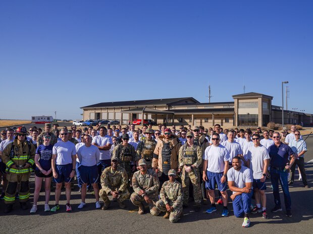 Airmen from the 9th Reconnaissance Wing pose for a group photo near Station 1 before commencing the 9/11 remembrance run at Beale Air Force Base, California, Sept. 11, 2024.