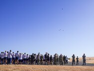Airmen from the 9th Reconnaissance Wing observe a missing-man formation flyover performed by T-38 Talons near Station 1, at Beale Air Force Base, California, Sept. 11, 2024.