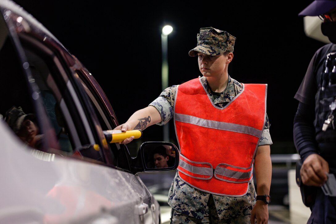 U.S. Marine Corps Cpl. Priya Hasham, meteorology analyst forecaster with 31st Marine Expeditionary Unit conducts field breathalyzer tests at a vehicle gate on Camp Hansen, Okinawa, Japan, July 19, 2024.