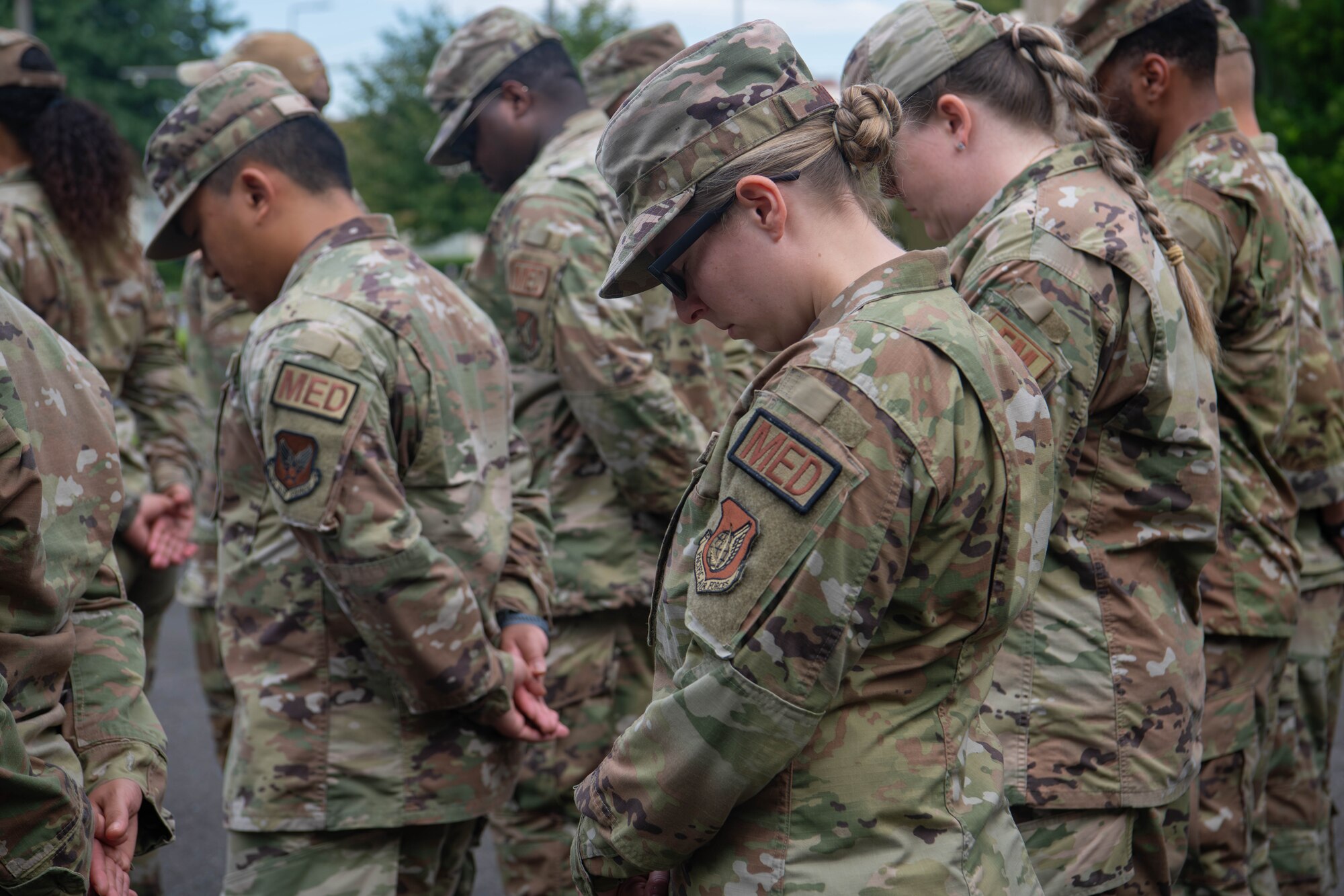 Members of the 374th Airlift Wing bow their heads in silent vigil at the National POW/MIA Recognition Day closing ceremony.