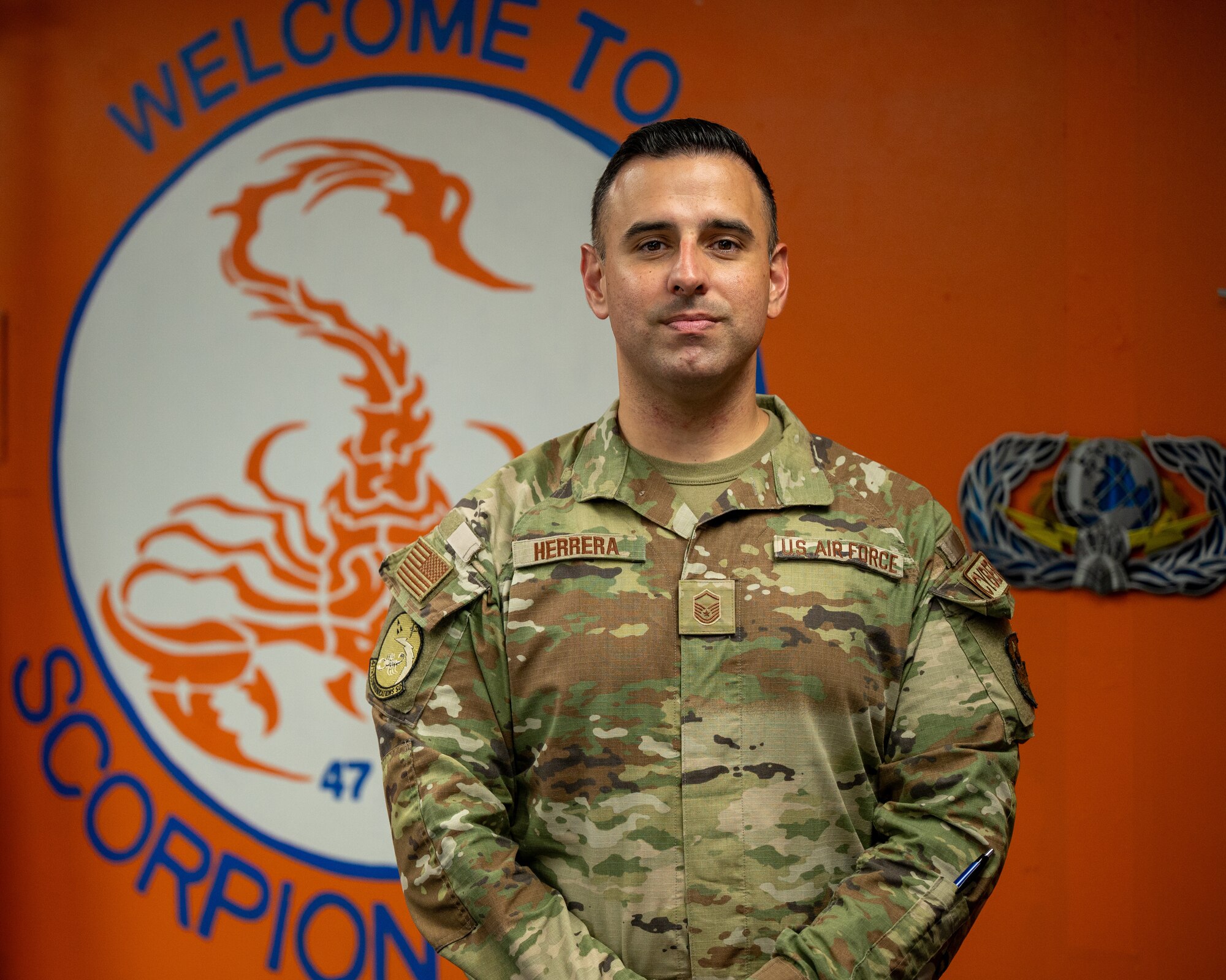 U.S. Air Force Master Sgt. David Herrera, 47th Communication Squadron (CS) network control center section chief, poses for a portrait photo in front of the 47th CS seal at Laughlin Air Force Base, Texas, Sept. 9, 2024. Herrera won the Department of the Air Force Chief Information Officer Outstanding Professional of the Year. (U.S. Air Force photo by Staff Sgt. Nicholas Larsen)