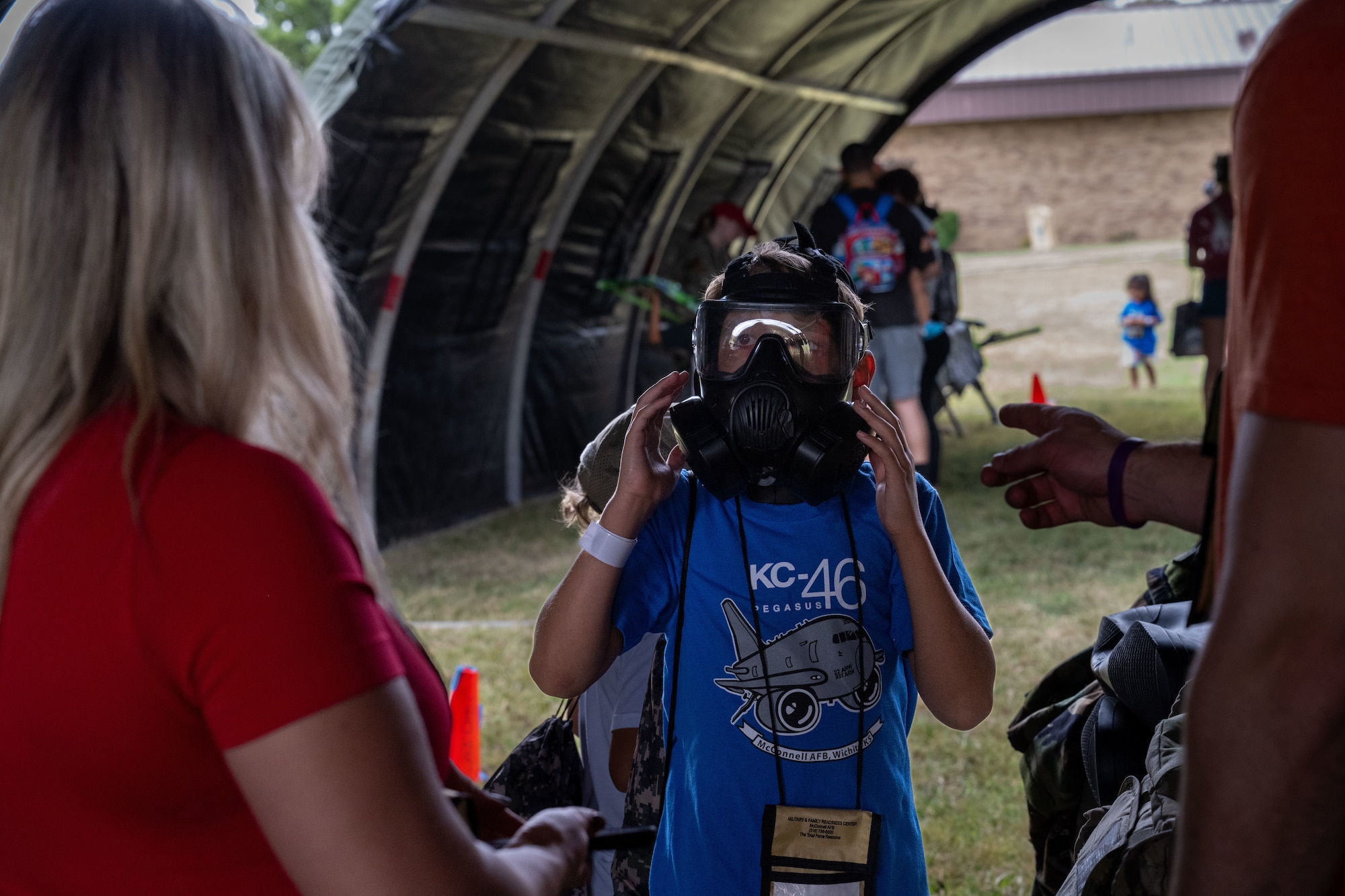 A Family Mobility Line attendant tours a chemical, biological, radiological and nuclear materials display on Sept. 21, at McConnell Air Force Base, Kansas. CBRN is responsible for protection, decontamination, response planning and detection. (U.S. Air Force photo by Airman 1st Class Paula Arce)