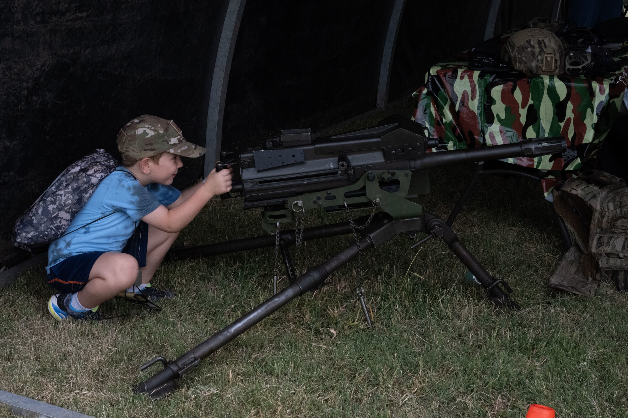 A Family Mobility Line attendant tours a weapons display Sept. 21, at McConnell Air Force Base, Kansas. The event was for service members’ families to experience and understand the deployment process. (U.S. Air Force photo by Airman 1st Class Paula Arce)