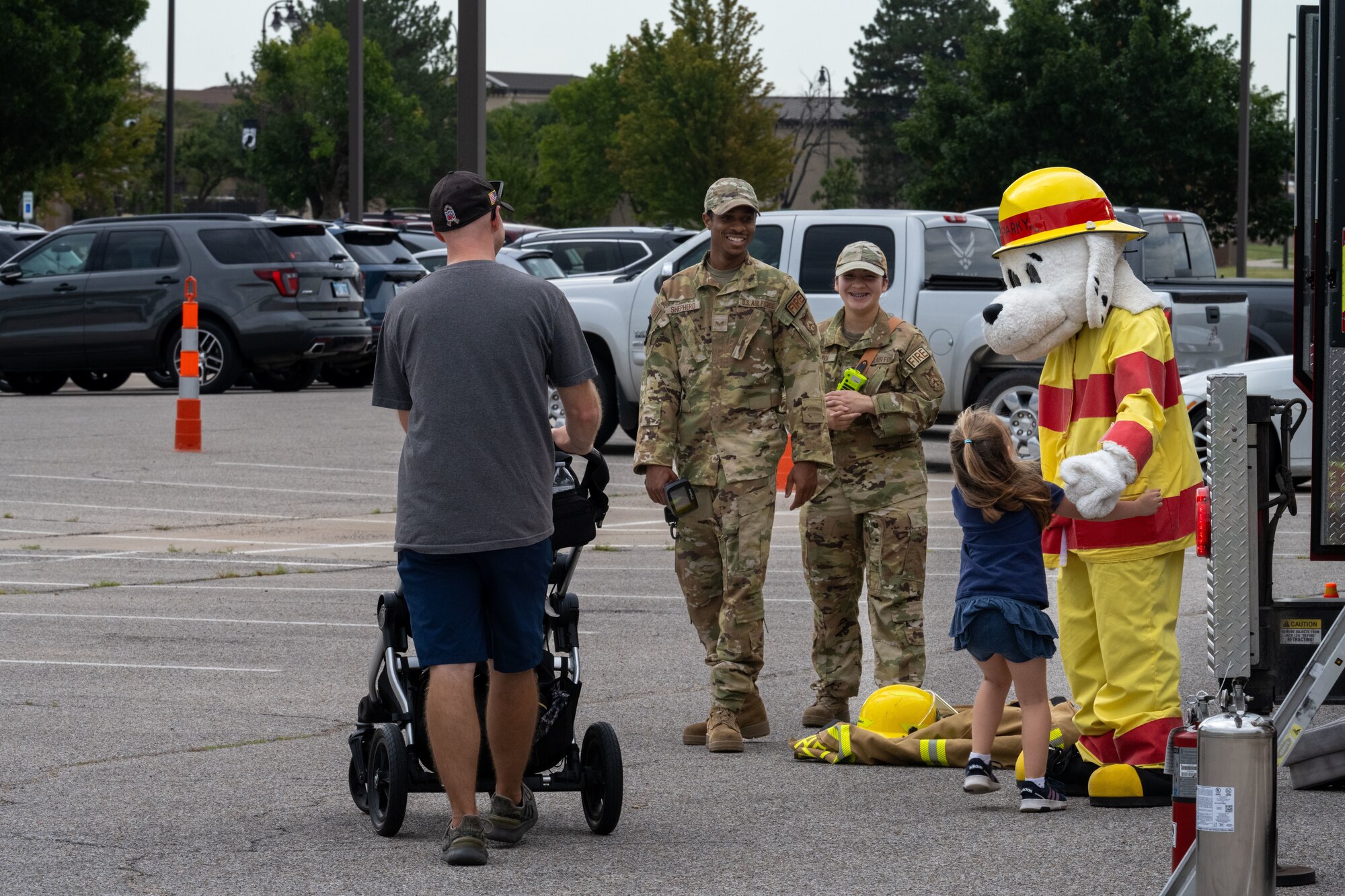 Sparky the Fire Dog meets with a Family Mobility Line attendant Sept. 21, at McConnell Air Force Base, Kansas. Sparky is the official mascot of the National Fire Protection Association and serves as a symbol of safety. (U.S. Air Force photo by Airman 1st Class Paula Arce)