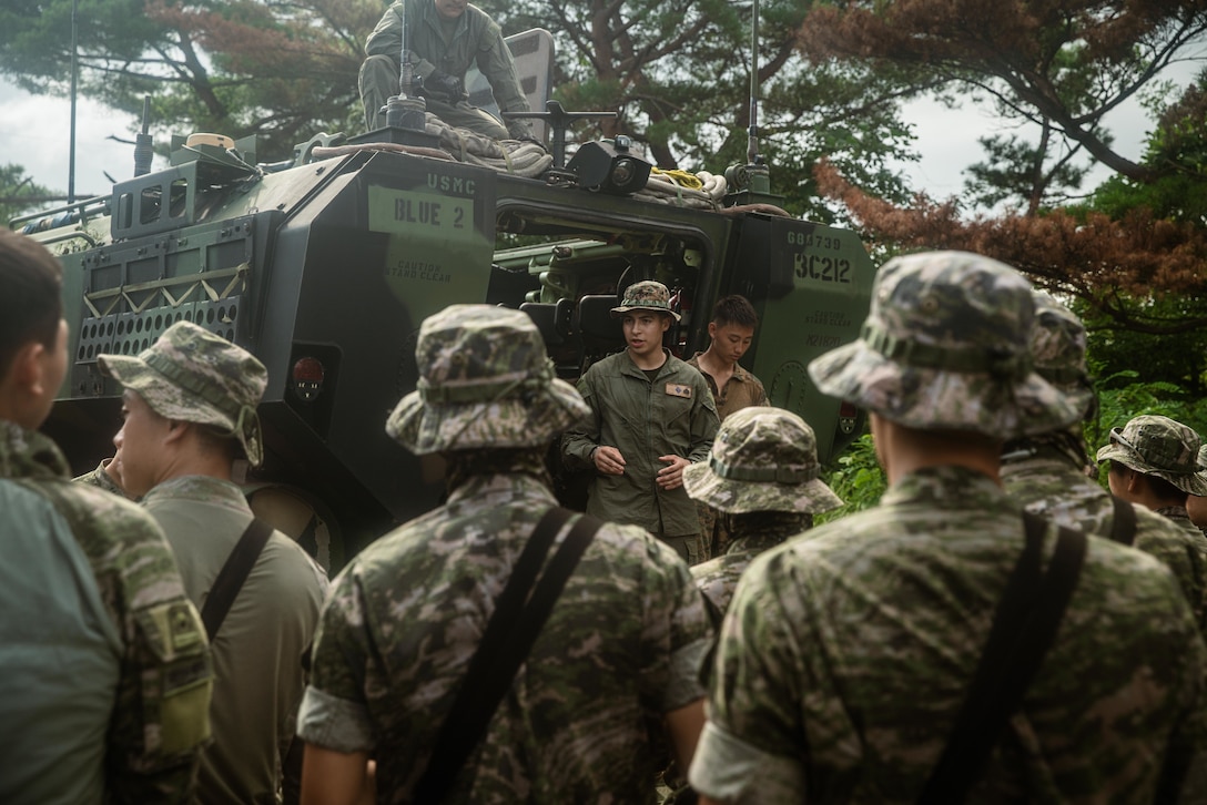 U.S. Marine Corps Sgt. Richard Espinoza, an amphibious combat vehicle commander assigned to Alpha Company, Battalion Landing Team 1/5, 15th Marine Expeditionary Unit, and a native of Utah, conducts a walk-through class covering the Amphibious Combat Vehicle with Republic of Korea (ROK) Marines assigned to 3rd Battalion, 7th Brigade, 1st ROK Marine Division, at Jeongcheon-ri, South Korea, Aug. 20, 2024. Integrated training between the two countries strengthens the ROK-U.S. Alliance through bilateral, joint training, contributing toward combined capability in defense of the Korean Peninsula. (U.S. Marine Corps photo by Lance Cpl. Peyton Kahle)