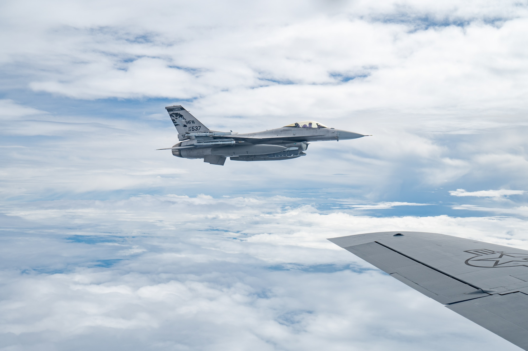 A U.S. Air Force F-16CM Fighting Falcon operated by the 179th Expeditionary Fighter Squadron flies echelon with a KC-135 Stratotanker for aerial refueling during exercise Southern Beach over the Pacific Ocean, Sept. 19, 2024. Kadena Air Base routinely conducts training, as it is critical to deterring aggression and being ready to fight and win to protect the vital interests of the U.S. and Japan. (U.S. Air Force photo by Senior Airman Tylir Meyer)
