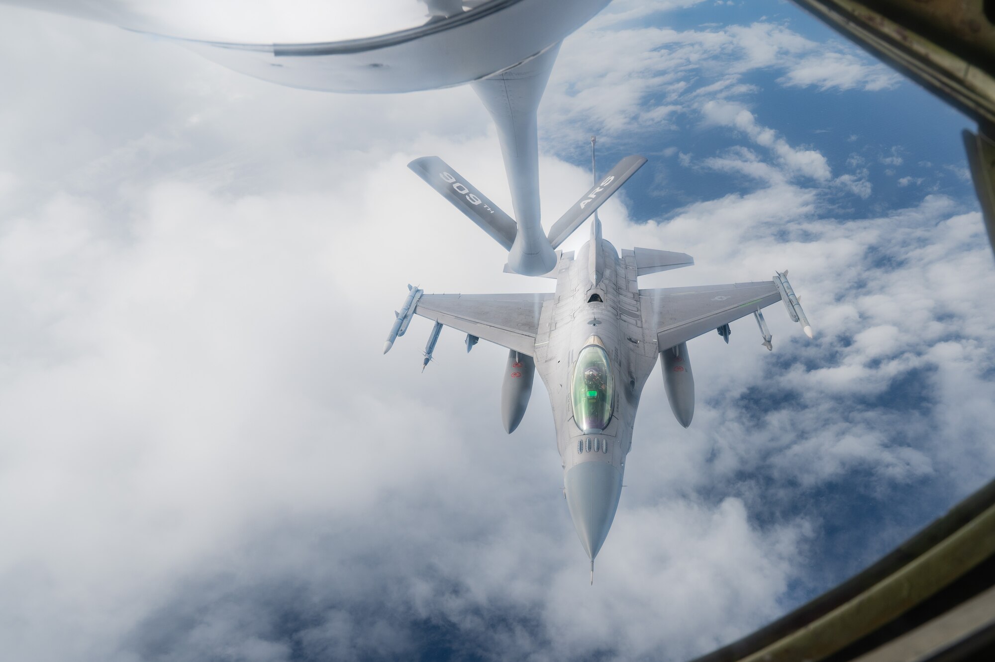 A U.S. Air Force F-16CM Fighting Falcon operated by the 179th Expeditionary Fighter Squadron approaches a KC-135 Stratotanker for aerial refueling during exercise Southern Beach over the Pacific Ocean, Sept. 19, 2024. Kadena Air Base serves as a hub for airpower in the Pacific, ensuring readiness to project force capabilities and provide support to regional allies and partners when called upon. (U.S. Air Force photo by Senior Airman Tylir Meyer)