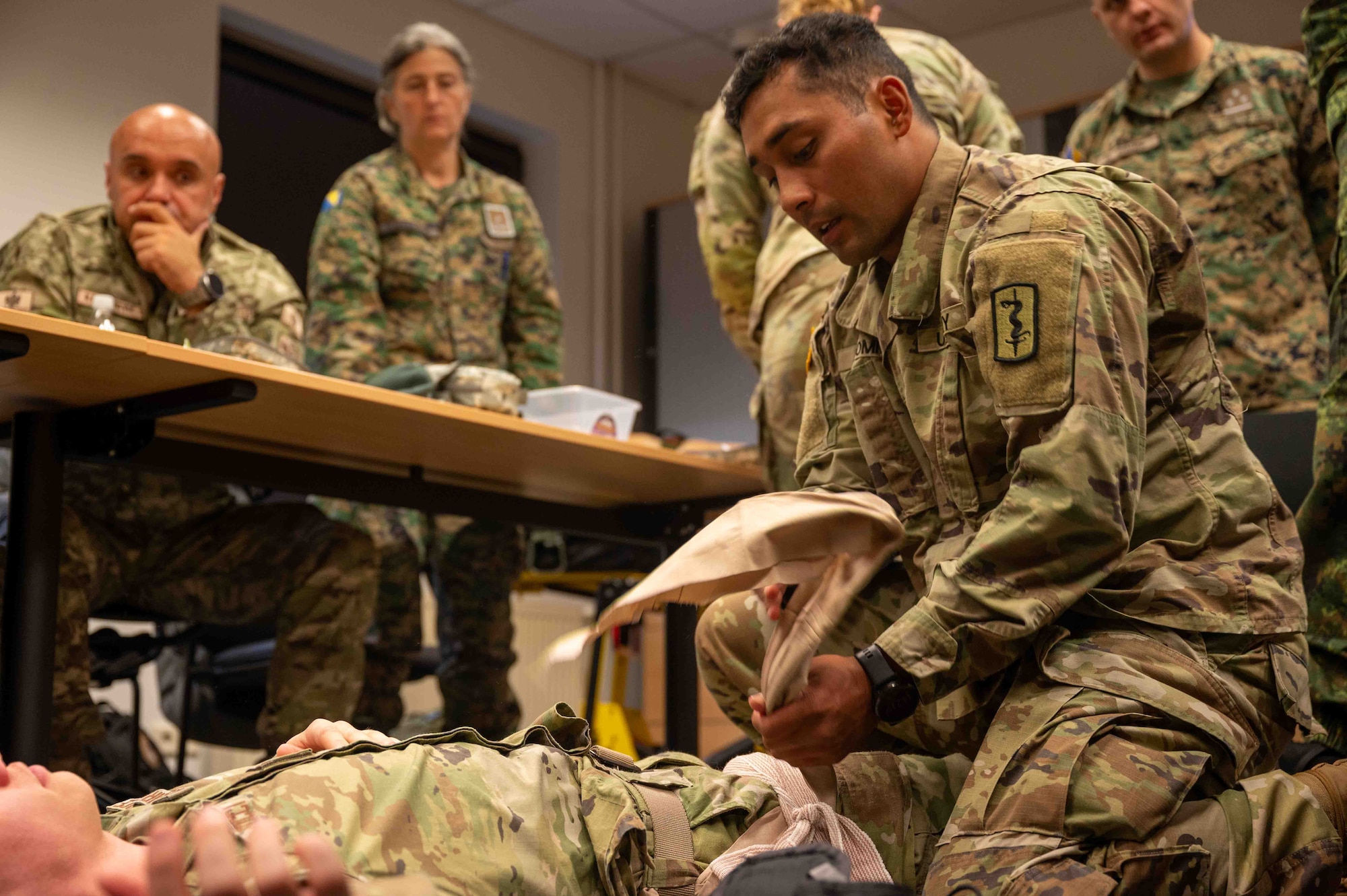 U.S. Army Master Sgt. Mario Leonmiti, 512th Field Hospital emergency room platoon sergeant, applies a junctional tourniquet to a patient during the European Role 1 Development week at Ramstein Air Base, Germany, Sept. 16, 2024.