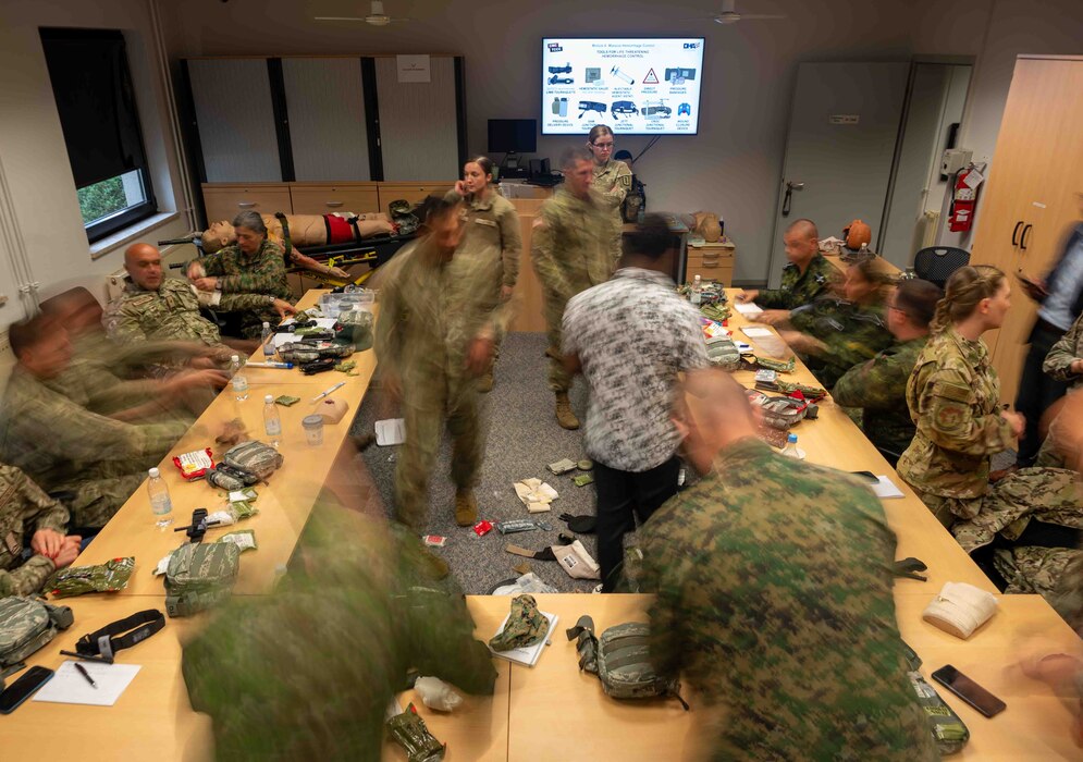 European Role 1 Development week participants from Bulgaria, Bosnia and Herzegovina, Montenegro, and Slovakia practice applying a tourniquet to a part of their body at Ramstein Air Base, Germany, Sept. 16, 2024.