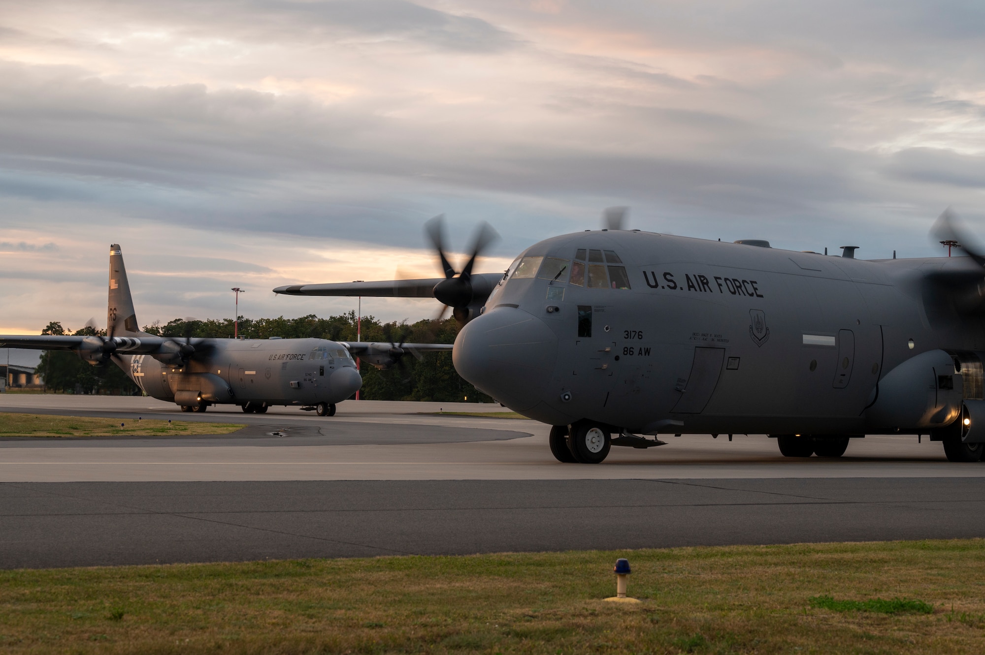 Two C-130s taxi