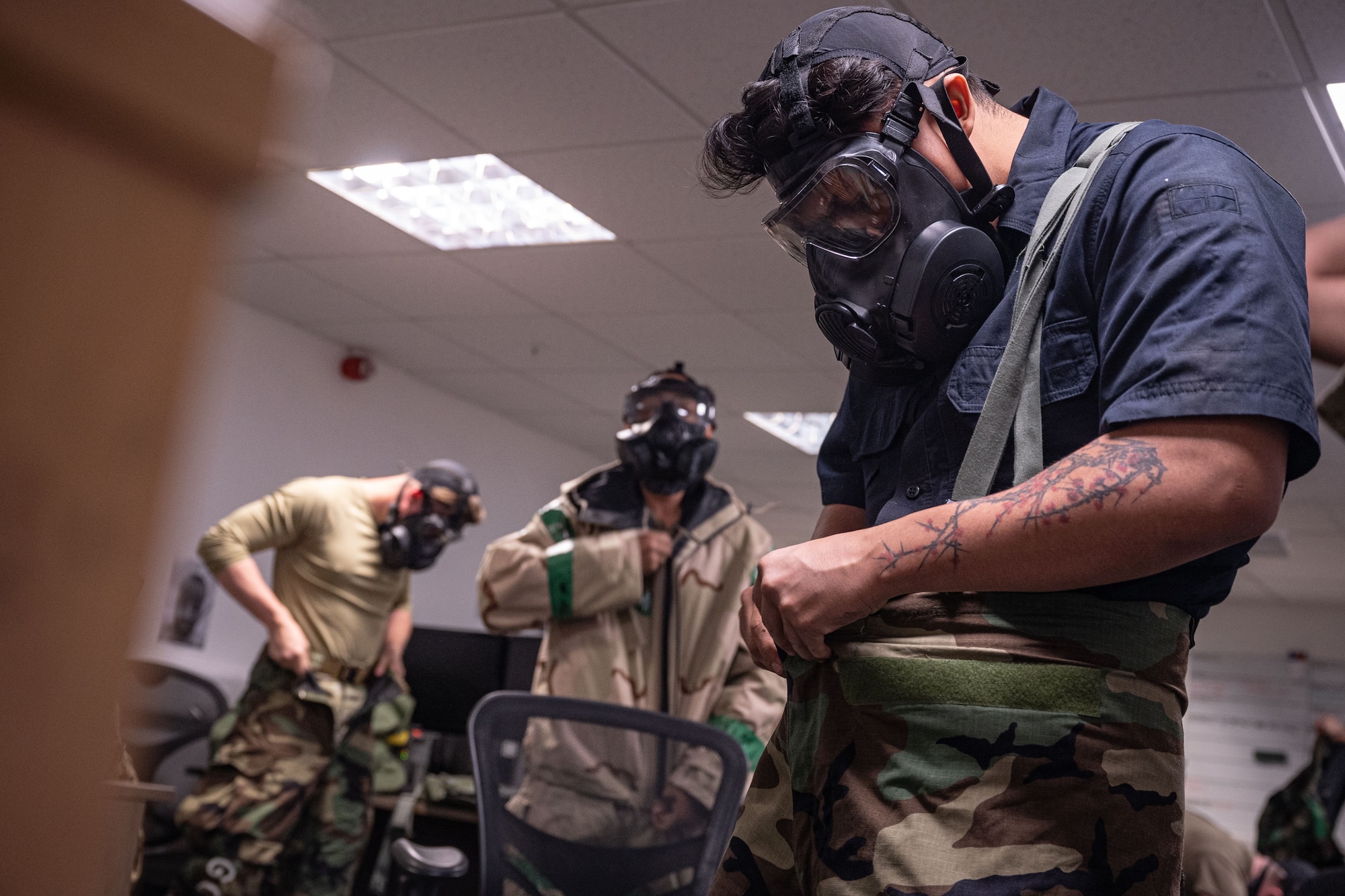 U.S. Airmen from the 100th Logistics Readiness Squadron Vehicle Management don their mission-oriented protective posture gear during a base readiness exercise at Royal Air Force Mildenhall, England, Sept. 20, 2024.