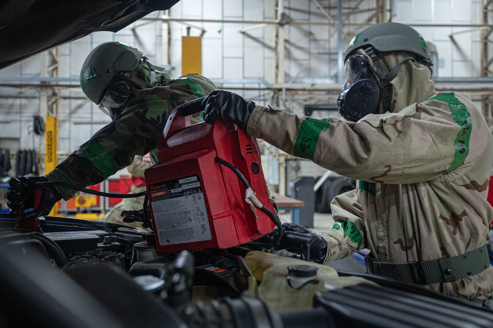 U.S. Airmen from the 100th Logistics Readiness Squadron Vehicle Management diagnose problems on a vehicle that was in need of repairs during a mock chemical attack during a base readiness exercise at Royal Air Force Mildenhall, England, Sept. 20, 2024.