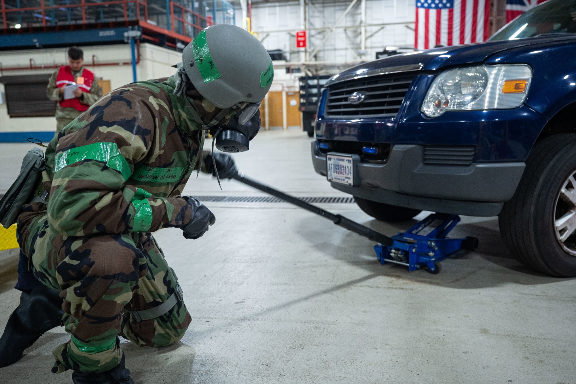U.S. Air Force Airman 1st Class Vashonn Bledsoe, 100th Logistics Readiness Squadron Vehicle Management general purpose maintenance apprentice, raises the front-end of a security forces vehicle in preparation to replace a tire during the base readiness exercise at Royal Air Force Mildenhall, England, Sept. 20, 2024.