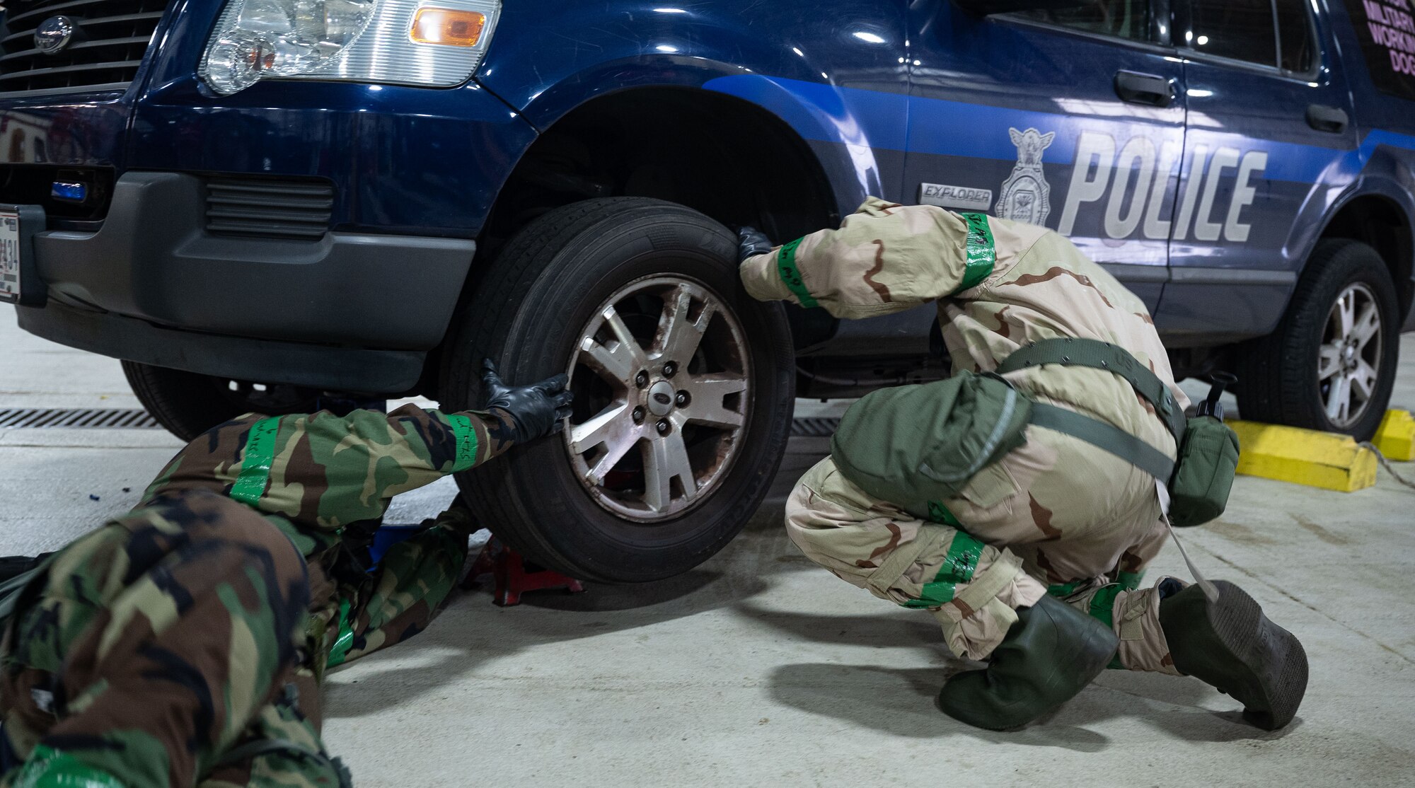 U.S. Airmen from the 100th Logistics Readiness Squadron inspect the wheel of a security forces vehicle during a base readiness exercise at Royal Air Force Mildenhall, England, Sept. 20, 2024.