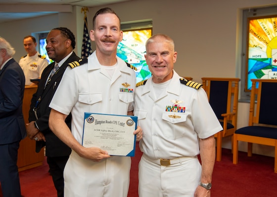 240920-N-MT837-1040 PORTSMOUTH, Va. (Sept. 20, 2024) Navy chaplain Lt. Cmdr. Jeff Birch, a graduate from the Pastoral Care Residency (PCR) program at Naval Medical Center Portsmouth (NMCP), poses for a photo with Capt. William Hlavin, the regional chaplain assigned to Naval Medical Forces Atlantic, on board Naval Support Activity (NSA) Hampton Roads - Portsmouth Annex, Sept. 20, 2024. The graduating Navy chaplains from NMCP include: Lt. Cmdr. Reggie Jones, who will serve at Expeditionary Medical Ship 3 (EMS 3) attached to NMRTC Fort Belvoir, Lt. Cmdr. Jeff Birch, who will be assigned to Expeditionary Medical Unit-4 (EMU 4) attached to Navy Medicine Readiness Training Command (NMRTC) Beaufort, Lt. Cmdr. Johnson Folahan heading to NMRTC Naples and Lt. Cmdr. Kevin Jackson at EMU 6 attached to NMRTC Bethesda. (U.S. Navy photo by Mass Commmunication Specialist 2nd Class Dylan Kinee)