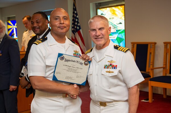 240920-N-MT837-1058 PORTSMOUTH, Va. (Sept. 20, 2024) Navy chaplain Lt. Cmdr. Reggie Jones a graduate from the Pastoral Care Residency (PCR) program at Naval Medical Center Portsmouth (NMCP), poses for a photo with Capt. William Hlavin, the regional chaplain assigned to Naval Medical Forces Atlantic, on board Naval Support Activity (NSA) Hampton Roads - Portsmouth Annex, Sept. 20, 2024. The graduating Navy chaplains from NMCP include: Lt. Cmdr. Reggie Jones, who will serve at Expeditionary Medical Ship 3 (EMS 3) attached to NMRTC Fort Belvoir, Lt. Cmdr. Jeff Birch, who will be assigned to Expeditionary Medical Unit-4 (EMU 4) attached to Navy Medicine Readiness Training Command (NMRTC) Beaufort, Lt. Cmdr. Johnson Folahan heading to NMRTC Naples and Lt. Cmdr. Kevin Jackson at EMU 6 attached to NMRTC Bethesda. (U.S. Navy photo by Mass Commmunication Specialist 2nd Class Dylan Kinee)