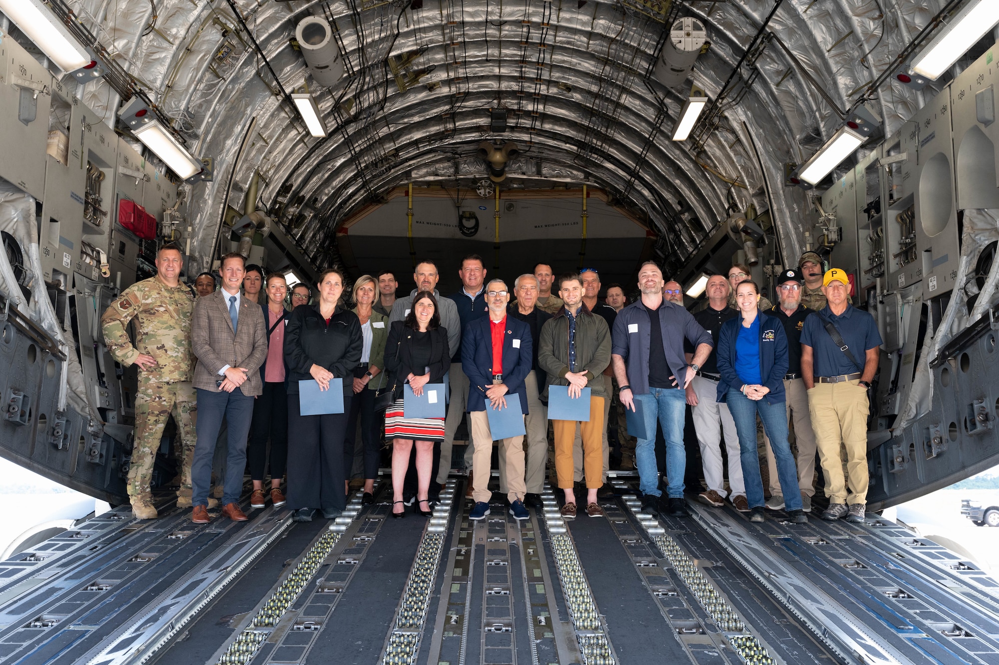 Col. Douglas Stouffer, 911th Airlift Wing commander, poses for a photo with the newest Steel City Honorary Commanders Association and five Pennsylvania State representatives aboard a C-17 Globemaster III