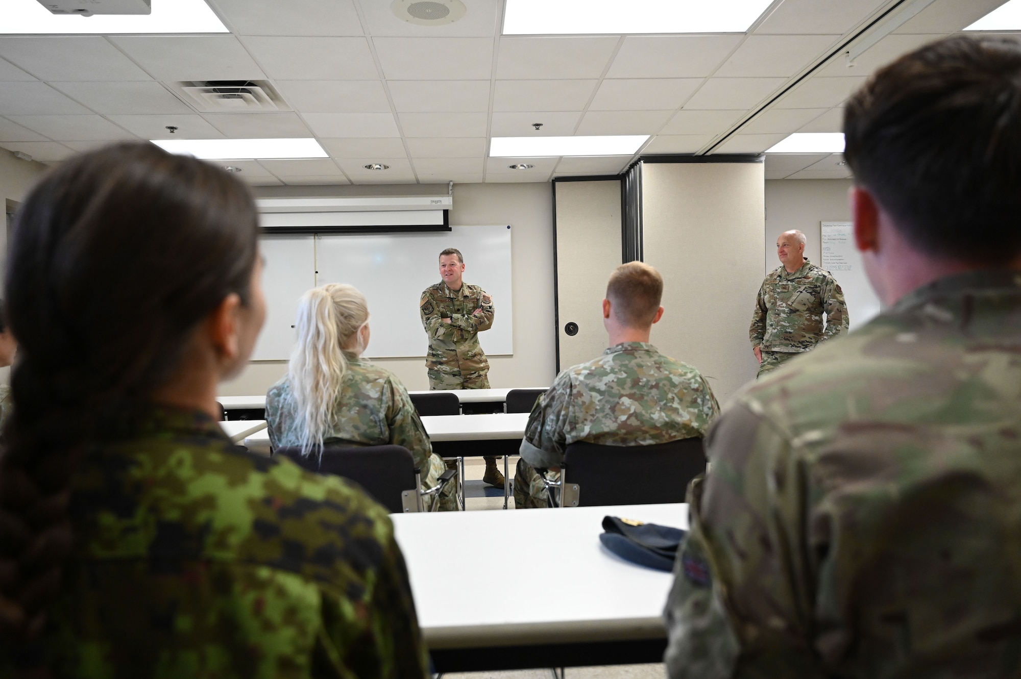 U.S. Air Force Lt Col Ryan Ormand, Acting Commander of the 123rd Air Control Squadron speaks to the visiting NATO members on the last day of a joint training exercise September 20, 2024 in Blue Ash, Ohio. The training brought together NATO service members from United Kingdom, Estonia, Lithuania, and Hungary and included air battle management, ground control intercept, large-force employment and air-to-air combat beyond visual range exercises. (U.S. Air National Guard photo by Senior Airman Colin Simpson)
