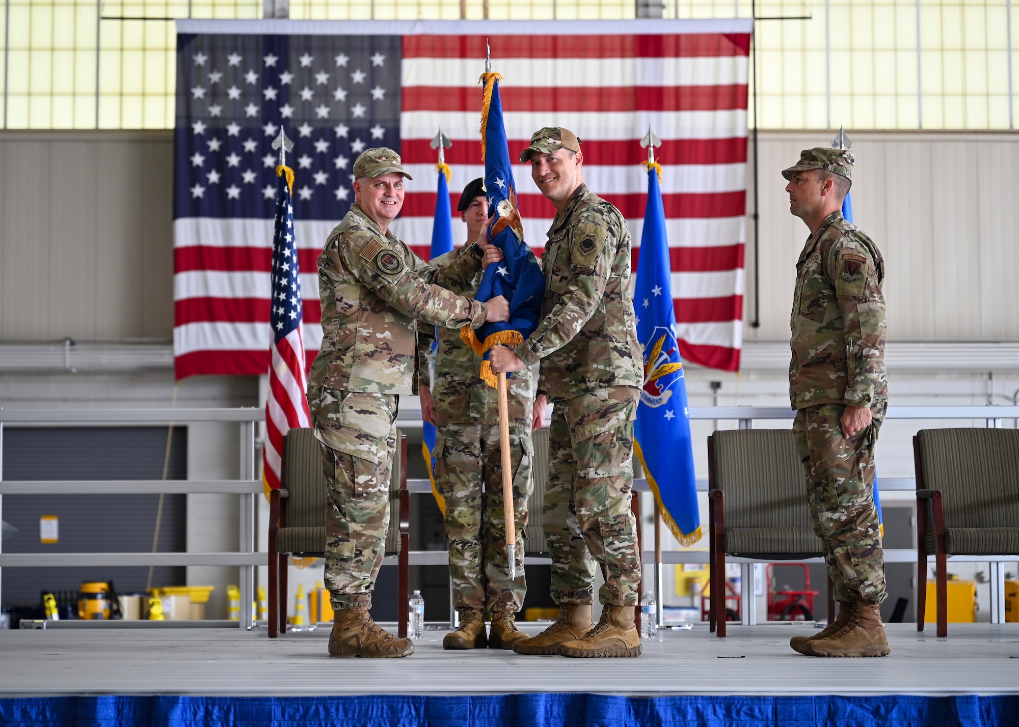 U.S. Air Force Lt. Gen. Michael Koscheski, deputy commander of Air Combat Command, passes the guidon to U.S. Air Force Col. Benjamin Donberg, 13th Air Task Force commander, Joint Base San Antonio, Texas, during an assumption of command ceremony