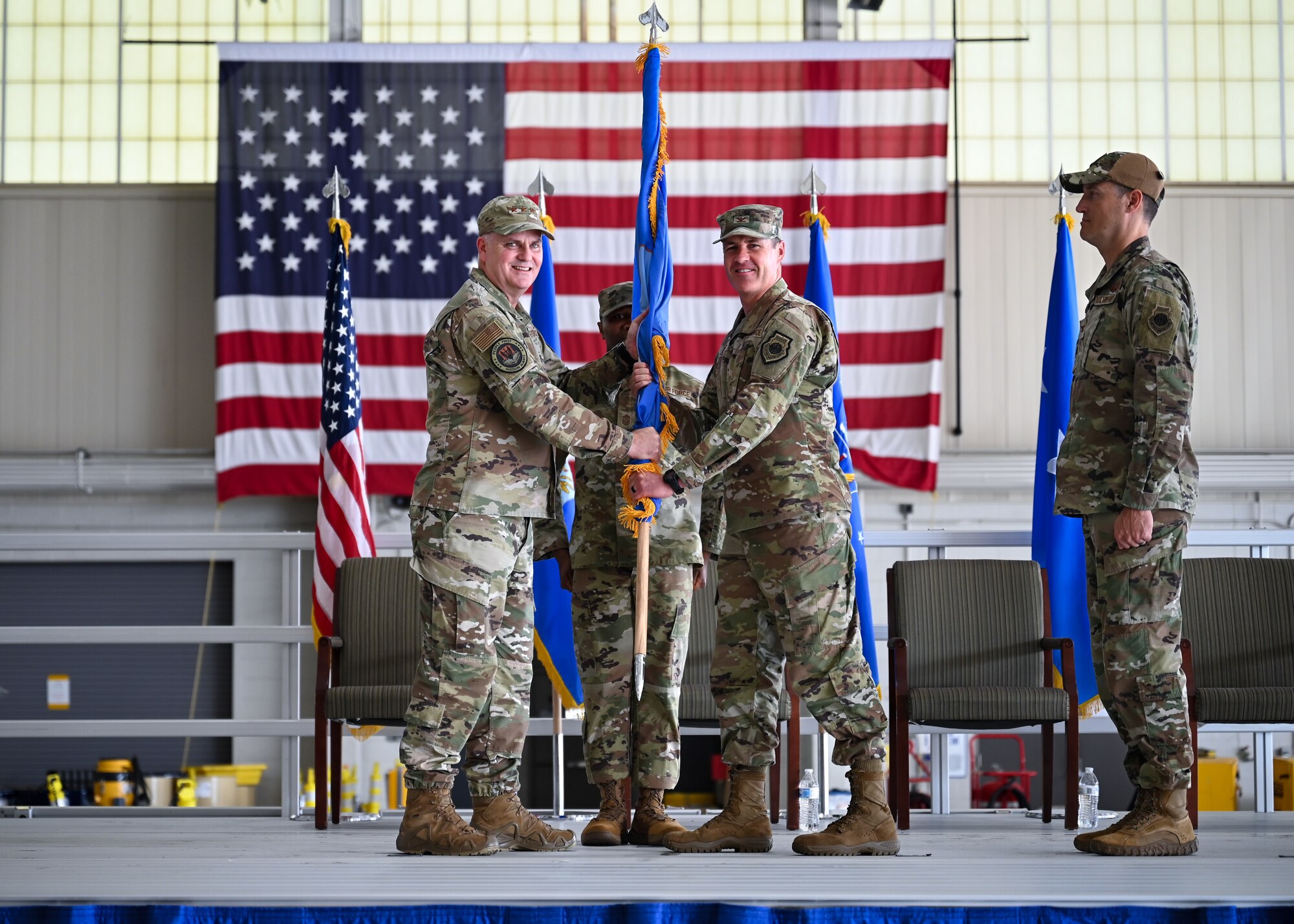 U.S. Air Force Lt. Gen. Michael Koscheski, deputy commander of Air Combat Command, passes the guidon to U.S. Air Force Col. Bradley Baker, 23rd Air Task Force commander, Seymour Johnson Air Force Base, North Carolina, during an assumption of command ceremony