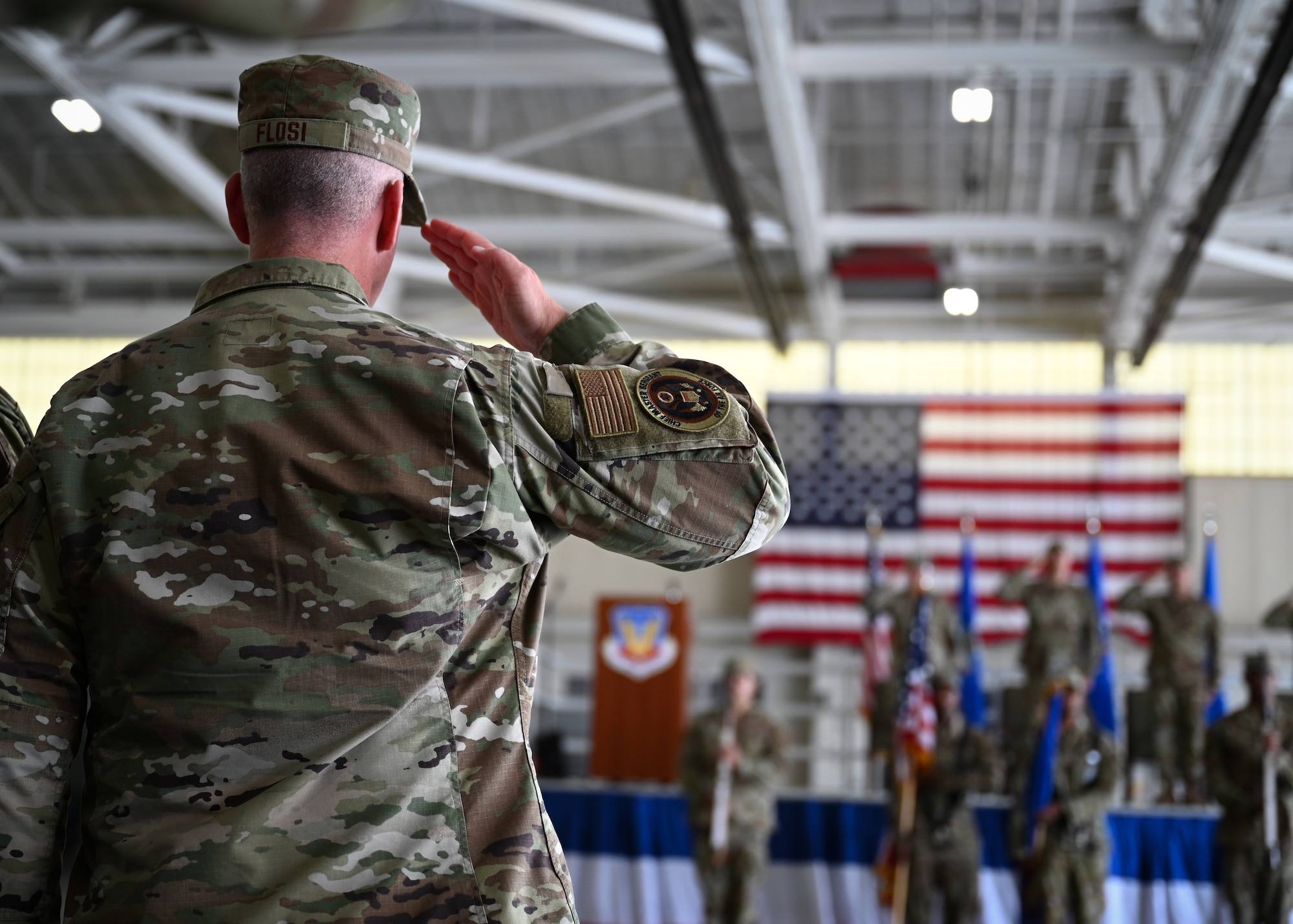 Chief Master Sgt. of the Air Force David Flosi salutes during an assumption of command ceremony