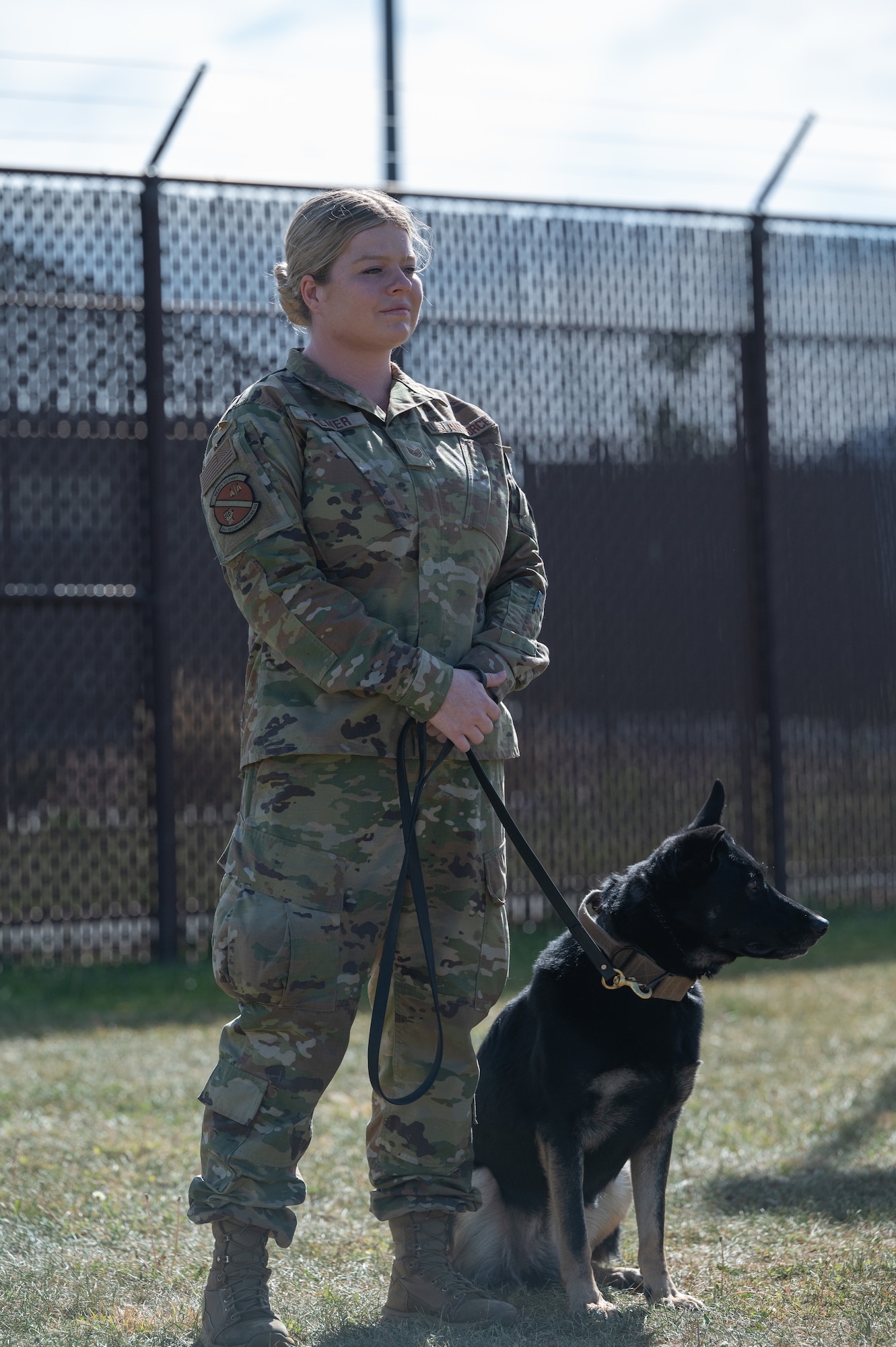 U.S. Air Force Staff Sgt. McKinley Palmer, 21st Security Forces Squadron military dog trainer, and Queny, 21st Security Forces Squadron military working dog, are waiting to begin their presentation during the immersion tour.