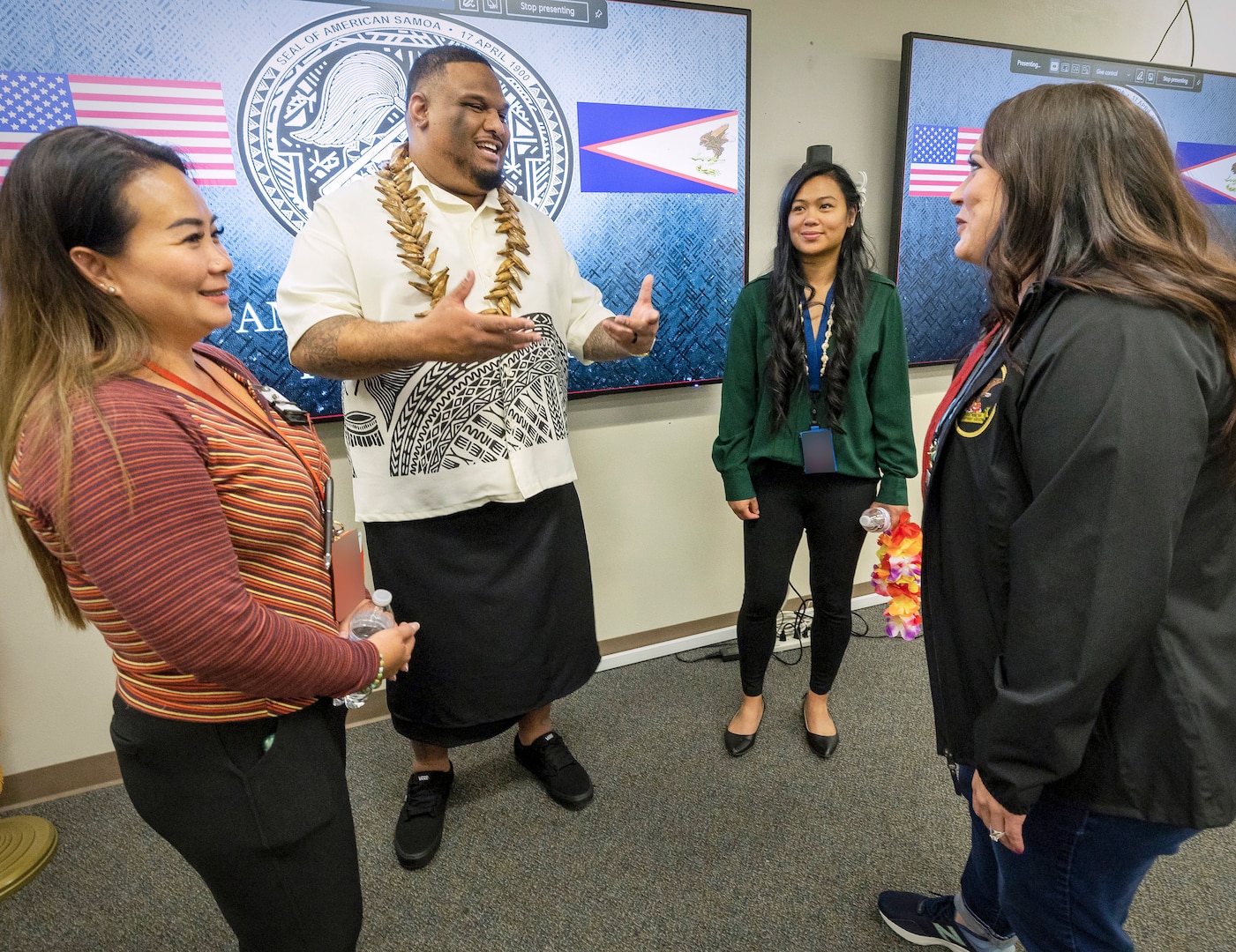 Villiamu Kuaea, Asian American-Pacific Islander Employee Resource Group co-lead, chats with ERG members April 18, 2023, during an American Samoa Flag Day celebration in the Horseshoe Conference Room in Building 850 at Puget Sound Naval Shipyard & Intermediate Maintenance Facility in Bremerton, Washington. (US Navy photo By Wendy Hallmark)