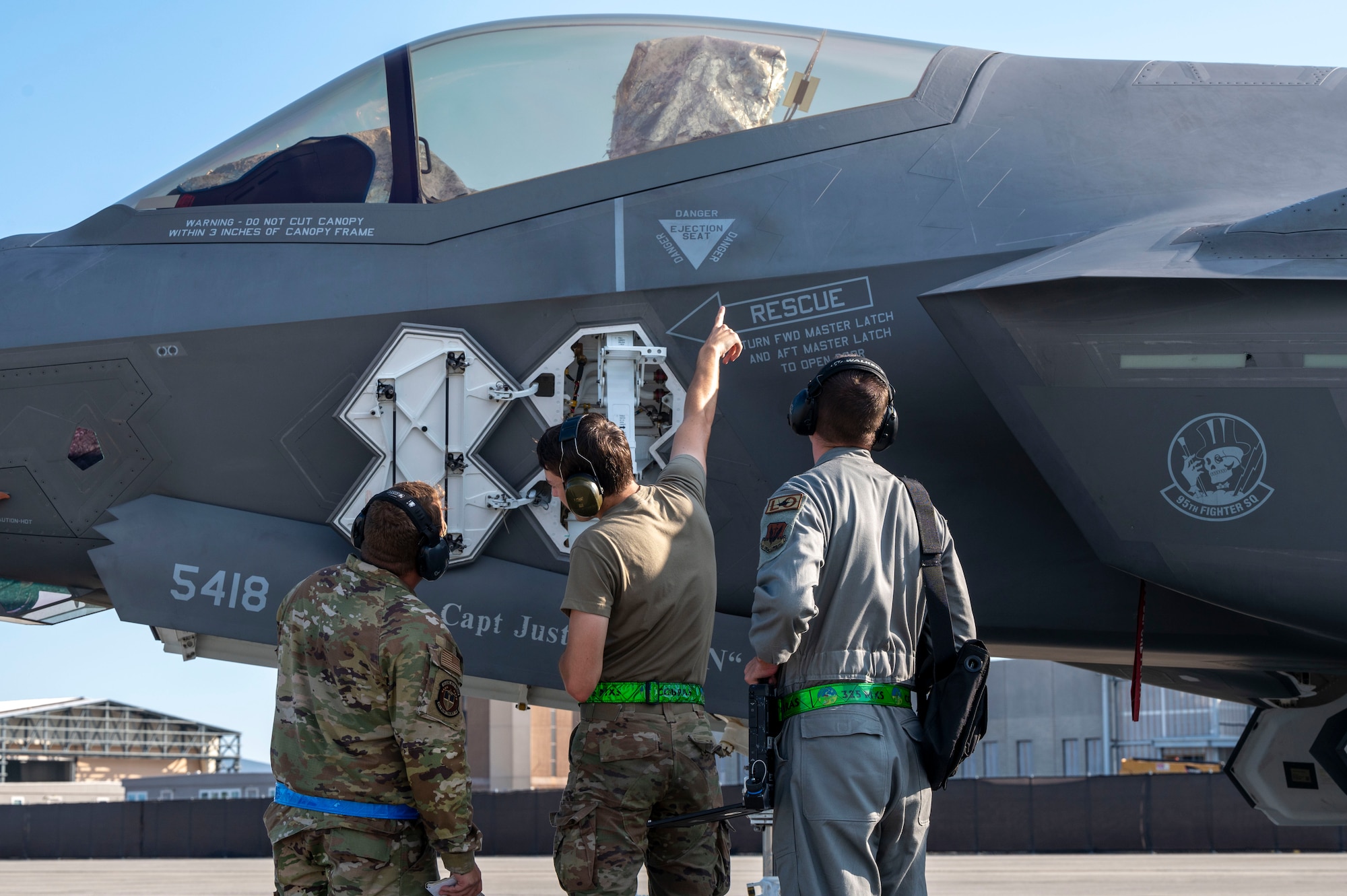 airmen talk next to plan