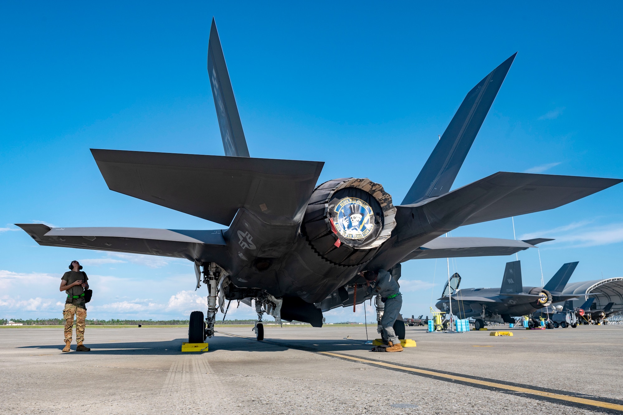 Airmen look under plane