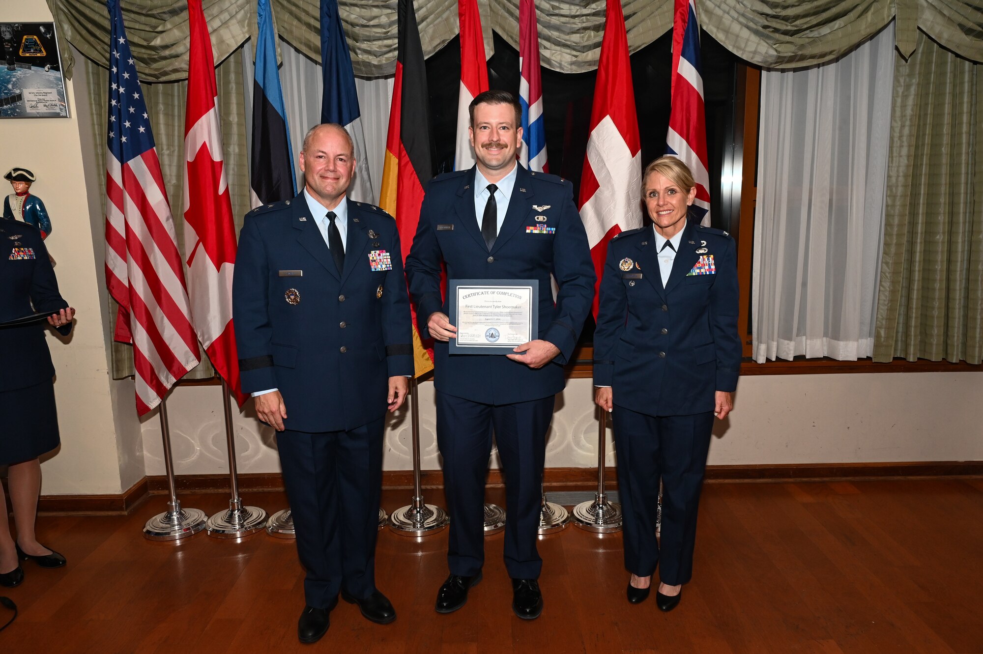 Airman receiving a course certificate