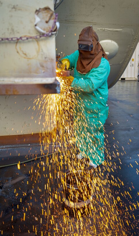 Gilbert Lizama, welder, Shop 26, Welders, works on a Reactor Compartment Disposal package in Dry Dock 3 Sept. 12, 2024, while preparing it for shipping, at Puget Sound Naval Shipyard & Intermediate Maintenance Facility in Bremerton, Washington. (U.S. Navy photo by Wendy Hallmark)
