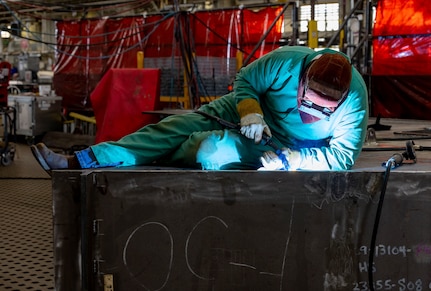 Parker McKane, welder, Shop 26, Welders, works on a section of a Reactor Compartment Disposal package in Building 460, Sept. 11, 2024, at Puget Sound Naval Shipyard & Intermediate Maintenance Facility in Bremerton, Washington. Shop 26 recently completed its fourth RCD package with zero rejectable conditions on all volumetrically inspected weld joints. Volumetrically inspected joints are critical welds used on all submarines and aircraft carriers. The welds are inspected using ultrasound or radiographic equipment. (U.S. Navy photo by Wendy Hallmark)