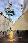 Gilbert Lizama, welder, Shop 26, Welders, works on a Reactor Compartment Disposal package in Dry Dock 3 Sept. 12, 2024, while preparing it for shipping at Puget Sound Naval Shipyard & Intermediate Maintenance Facility in Bremerton, Washington. (U.S. Navy photo by Wendy Hallmark)
